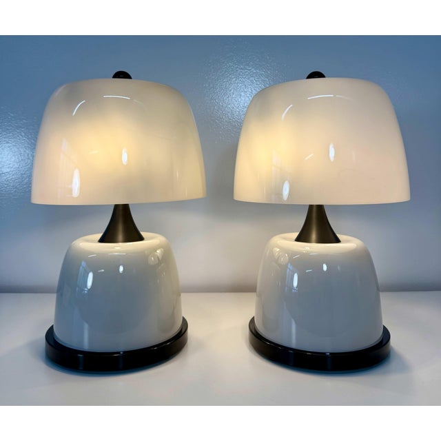 Elegant pair of sculptural table lamps crafted in Murano, Italy. Each lamp features a generously proportioned shade in...