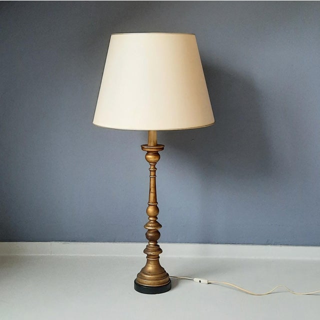 Italian, Florentine large wooden table lamp with gold paint layer. The shade is not part of this item and is for...