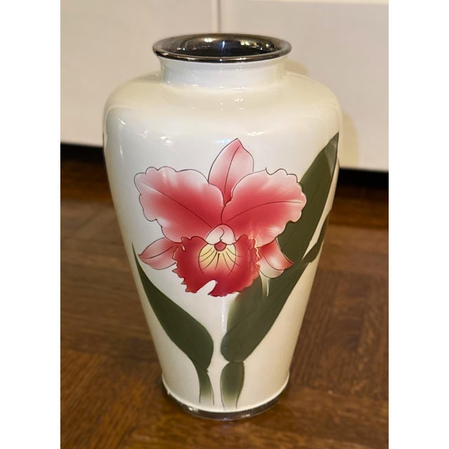 A beautifully hand‑painted porcelain vase in a cloisonné‑style aesthetic, featuring a bright pink peony on a glossy white...