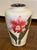 A beautifully hand‑painted porcelain vase in a cloisonné‑style aesthetic, featuring a bright pink peony on a glossy white...