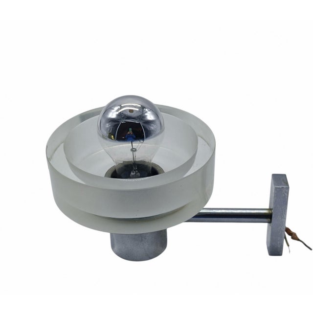 Wall lamp designed by Flavio Poli for Seguso in the 1960s. This wall lamp, with a chrome-plated metal frame, features a...