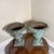 stunning vintage pair of French Country-style cast iron garden urn planters. Featuring a beautifully aged verdigris green...