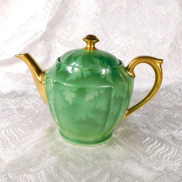 This is a green on green leaf patterned teapot by Pickard. I cannot find a pattern name for this item. The teapot comes...
