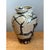 This vintage stoneware vase is a rugged, deeply tactile object, its broad, shouldered body tapering gracefully to a narrow...