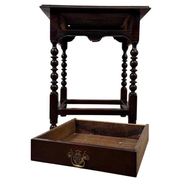 A handsome 19th-century English side table, finely crafted from oak and distinguished by its elegant bobbin-turned...