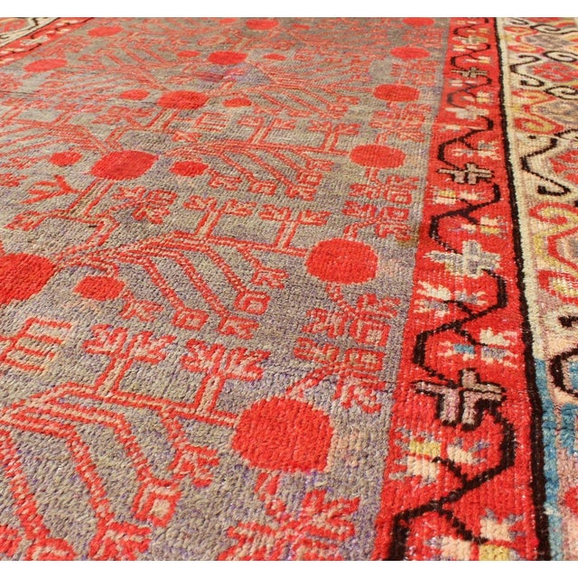 Measures: 3'10'' x 8'1''. This unique antique Khotan rug is a spectacular testament to the complexity of Turkestan design....