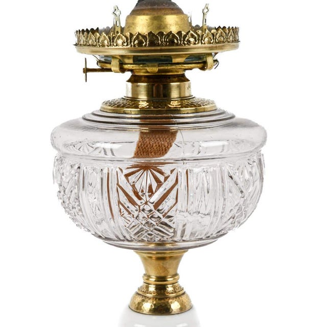 This Antique Victorian Milk Glass, Crystal, and Brass Oil Lamp exemplifies the ornate craftsmanship and decorative...