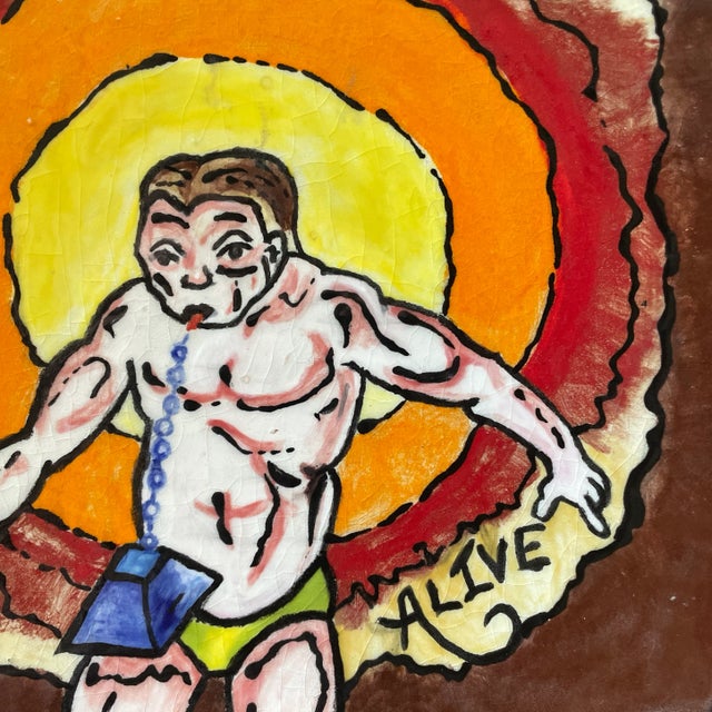 Hand-painted plate picturing the iron tongued man, an attraction at traveling circus shows. An animated depiction after...