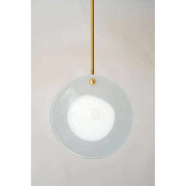 Eclipse pendant by atelier george one of a kind dimensions: ø 25 x 10 cm stem length : 30 cm materials: handblown glass,...