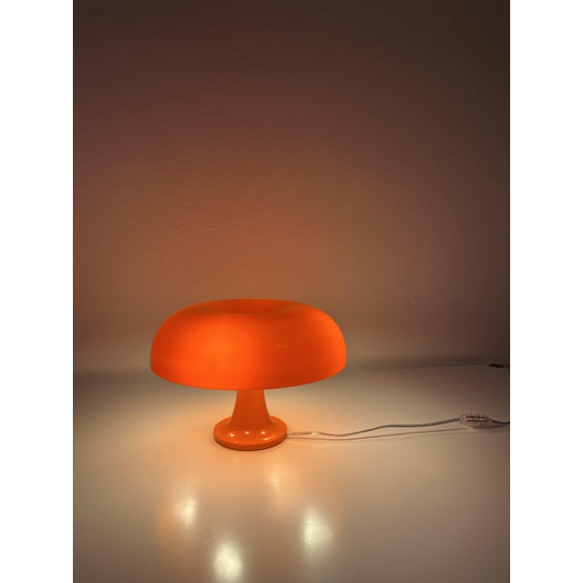 The Nessino table lamp by Artemide is an updated, smaller version of the legendary Nesso lamp designed in 1967 by...