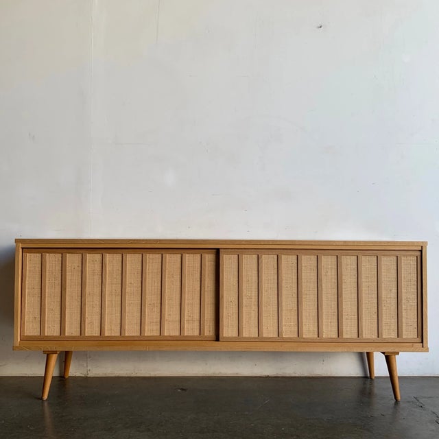 W72.25 D16 H28 Beautiful solid white oak and white oak veneer, doors feature oak accents with a cane mesh backdrop....