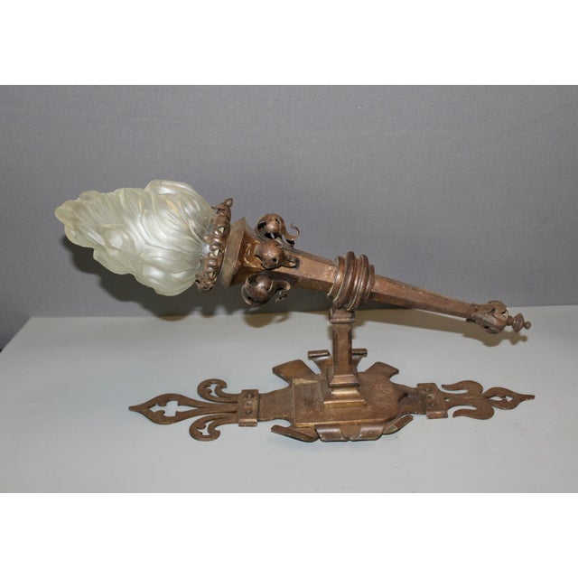 Important pair of Gothic style wrought iron wall sconces, molded glass flame-shaped fixtures, electrified, circa...