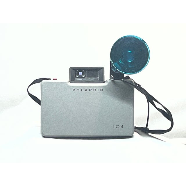 Add a touch of mid-century tech charm to your bookshelf, office, or gallery wall. This vintage Polaroid Automatic 104 Land...