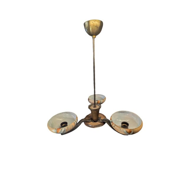 Designed by Paavo Tynell in the 1930s, the 1256/3 pendant lamp combines timeless design and carefully selected materials....