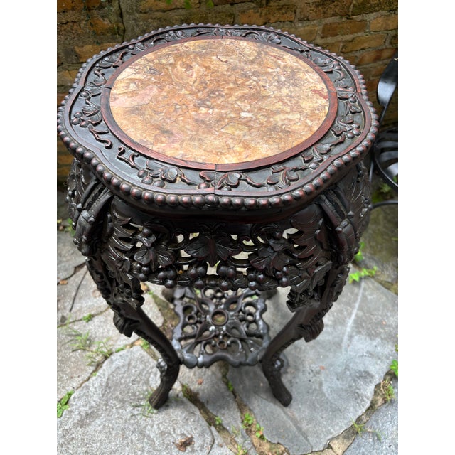Antique Chinese Rosewood Marble Top plant Stand. Solid wood frame, well carved, measuring 37 tall and 21 at her widest...