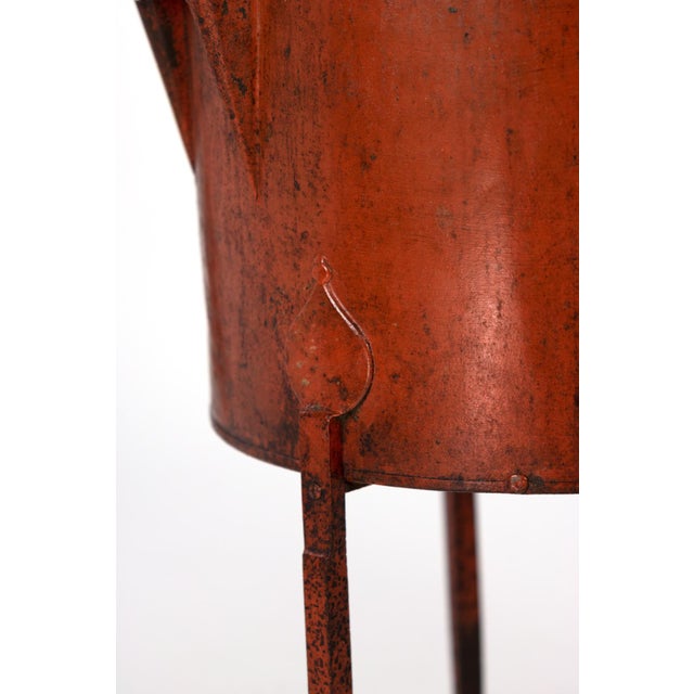 Persimmon color painted metal wine making barrel French circa 1860 on three iron legs. Manufacturer’s label reads: Top...