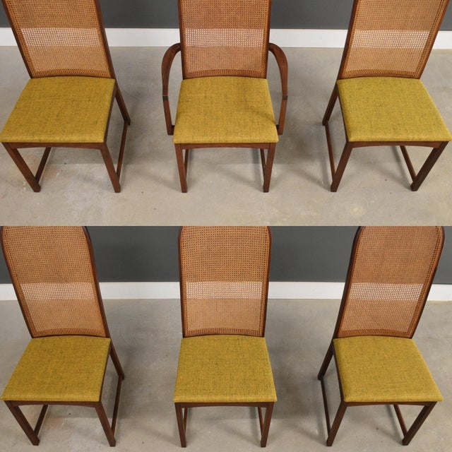 A set of six mid century modern solid walnut dining chairs with cane rounded backs designed by Milo Baughman for...