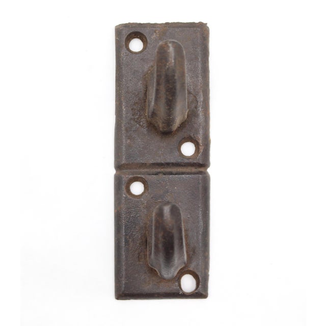 Reclaimed stacked two arm wall hook made of cast iron with a black finish. The original mounting screws are not available....