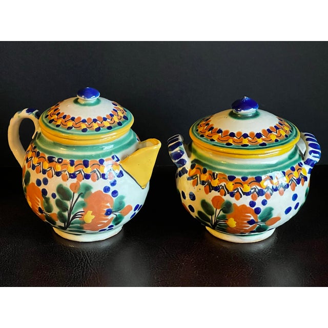 Early 20th Century signed Ysauro Uriarte Mexican Talavera earthenware lidded sugar and creamer. These pieces are believed...