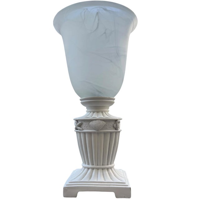 Elegant vintage urn-form table lamp with a beautifully detailed neoclassical silhouette and raised coastal shell and sea-...
