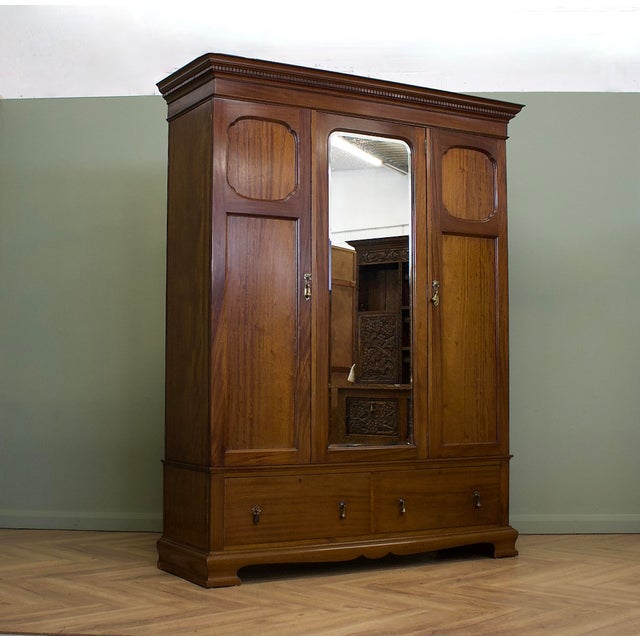 An impressive Edwardian triple wardrobe by renowned Glasgow cabinet makers A. Gardner & Son, retaining its original...