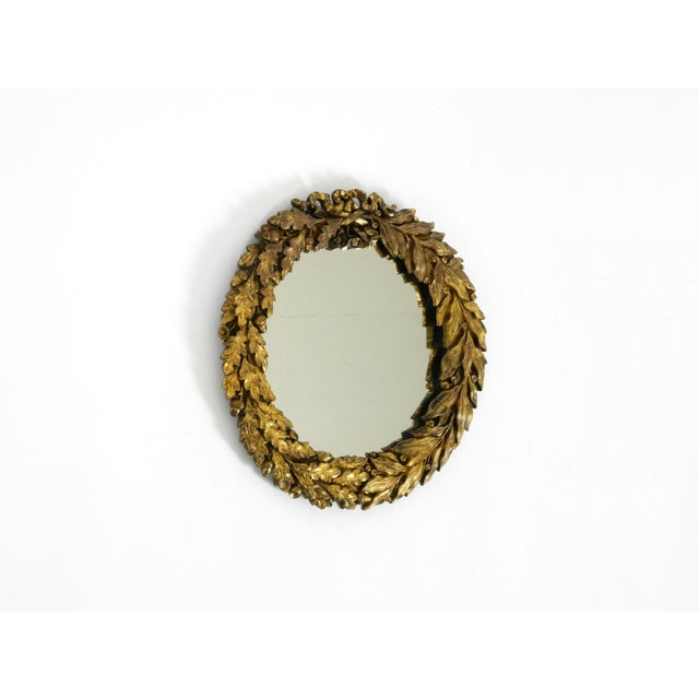 A beautiful, small, and heavy French Mid-Century wall mirror. It features a stunning, intricate design with a heavy,...