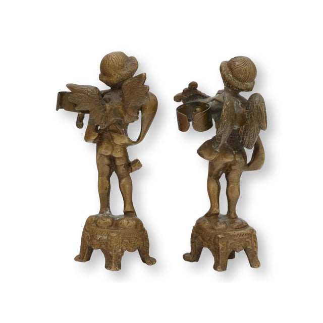 Pair of late nineteenth century French bronze cherub figures designed as flower or candle holders and complete with...