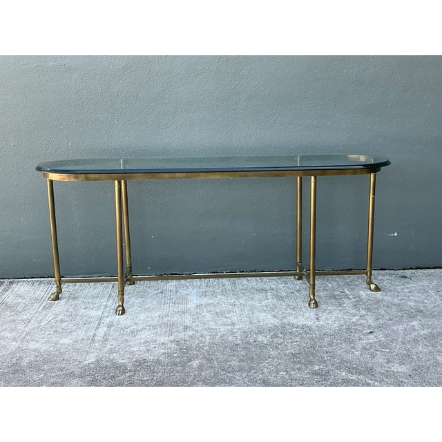 This vintage brass console table brings Mid-Century Modern character to any entryway or living space, anchored by a...