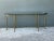 This vintage brass console table brings Mid-Century Modern character to any entryway or living space, anchored by a...