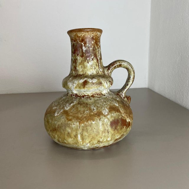 Article: Fat lava art vase. Producer: Ruscha, Germany. Decade: 1970s. This original vintage vase was produced in the 1970s...