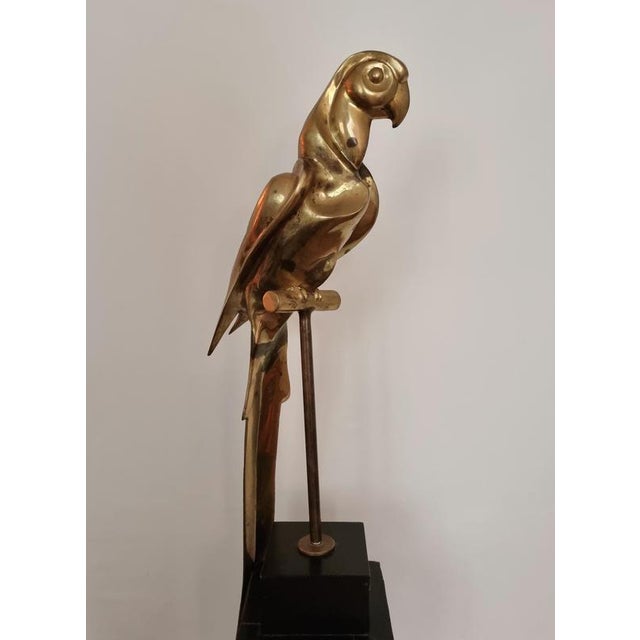 This rare brass sculpture in the shape of a parrot. with black painted wood base, is the perfect office buddy. Get...