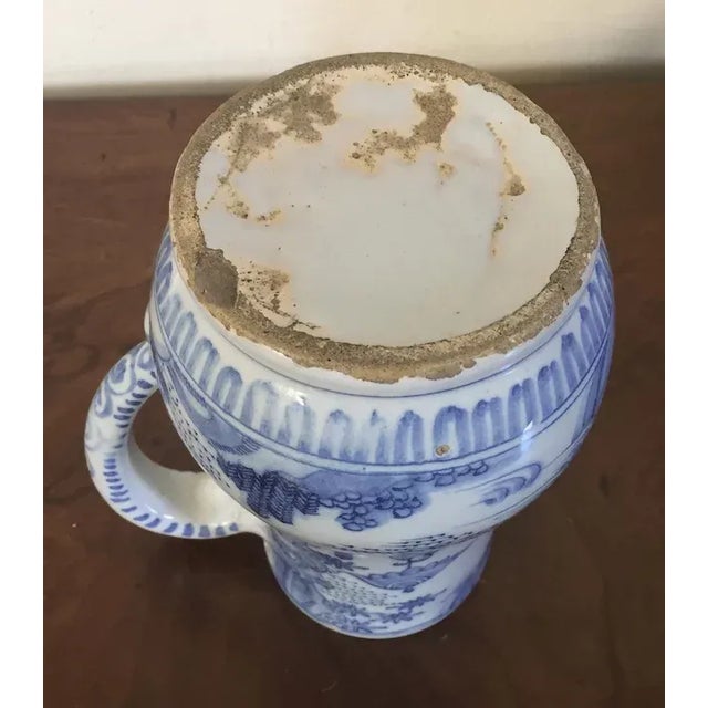 Antique 18th c. Delft tin glaze faience tankard mug in the Chinese taste. Decorated with a continuous landscape scene....