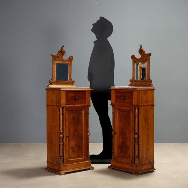 Pair of walnut nightstands dating back to the late 19th century, featuring a refined design and artisanal details. The top...
