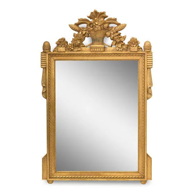 An impressive pair of reproduction gold gilt mirrors. The frames are very decorative with crests of floral baskets and...