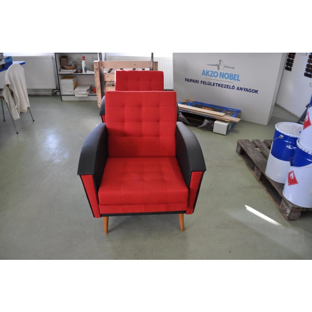This pair of vintage red lounge chairs comes in the Danish style and dates from the 60s. They have been reupholstered.