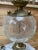 This vintage table lamp looks gorgeous located near a window, with light catching the detailed crackled glass globe; the...