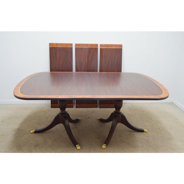 Dining Table by Henkel Harris. Store item #562. It features banded top and comes with protective pads and three leaves...