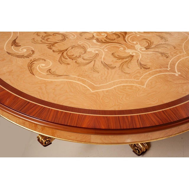 Handcrafted in Italy, this elegant round dining table features a beautifully detailed marquetry top crafted from fine...