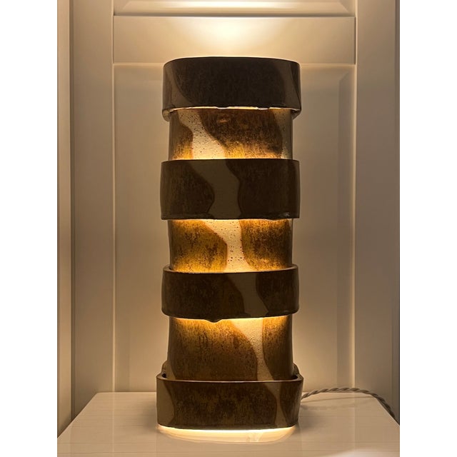 The “Layers” limited edition table lamp features a handcrafted ceramic body defined by glazed stacked bands. Suited for...