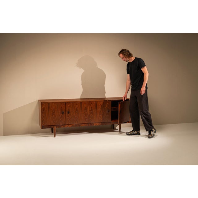 Clean proportions, carefully considered details and exceptional rosewood make this sideboard a beautiful example of Danish...