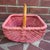 This vintage wicker gathering basket is painted a soft dusty rose and woven in a square shape with a bamboo cane handle....