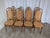 Vintage bentwood dining chairs featuring a high cane backrest and cane seat. Made in former Yugoslavia in the 1970s,...