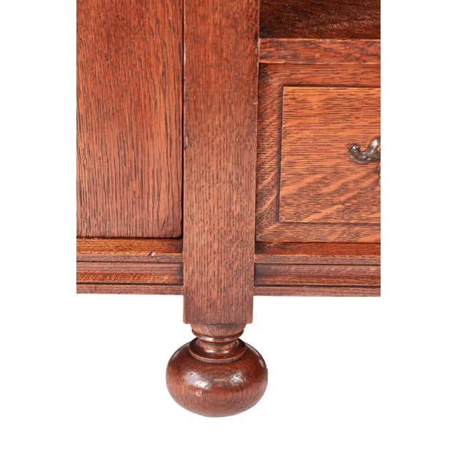 Outstanding quality oak Arts & Crafts sideboard having two unusual leaded glazed doors and a large bevel edge mirror to...