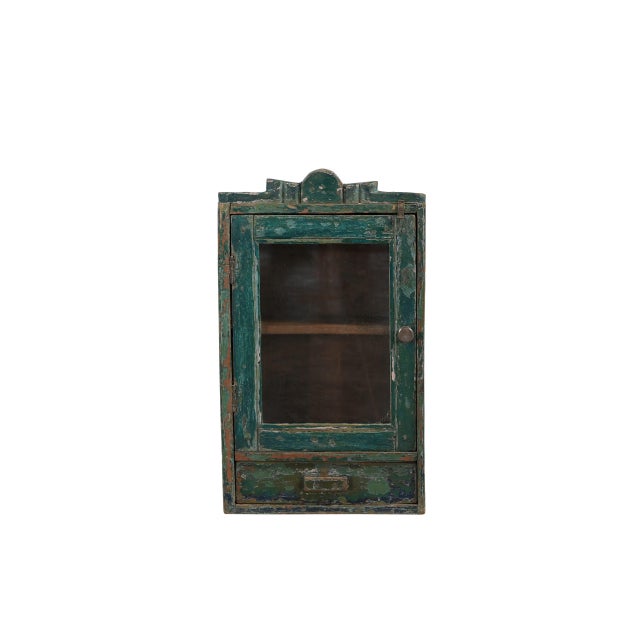 Vintage Indian Painted Hanging Cabinet, in its old green/blue paint finish with one glass door and drawer below. A great...