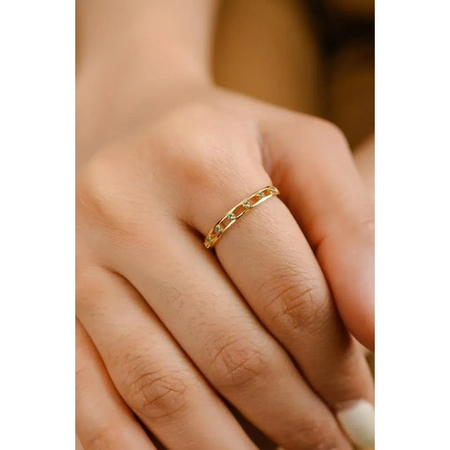 This is part of Chairish’s Fine Jewelry assortment. Dainty Natural Emerald Stackable Band Ring in 18K Gold symbolizes the...