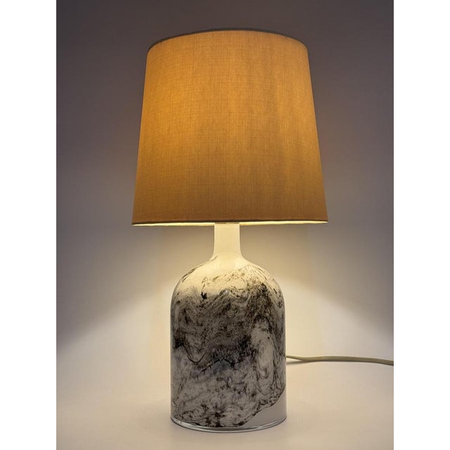 A table lamp * Holmegaard * Table lamp * Model: Symmetrisk * Designed by Michael Bang in the 1970s * Design object from...