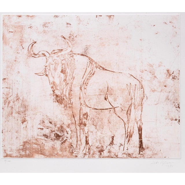 Buffalo is a wonderful brown burnt sienna ink linoleum original print on paper, realized in 1971 by the Italian master...