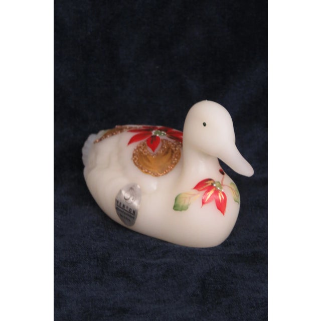 This highly charming Duck Figurine is made of glass. This Figurine was made by Fenton and it is labeled and sign by the...
