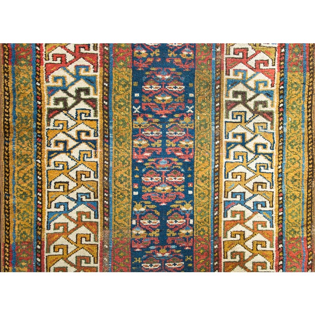 A wonderful early 20th century Persian Kurdish runner with a narrow stylized floral pattern in the center, and surrounded...