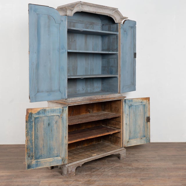 Early 19th century Swedish wedding cabinet, crafted in pine and built in two sections. The upper cabinet opens to reveal...